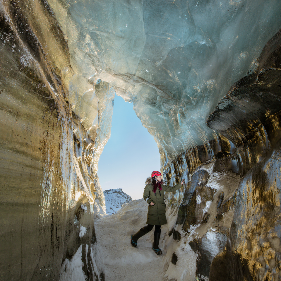 Hiker inside Blue Ice Cave at Katla