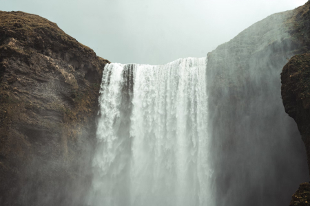 Skogafoss Waterfall misting over the mountains