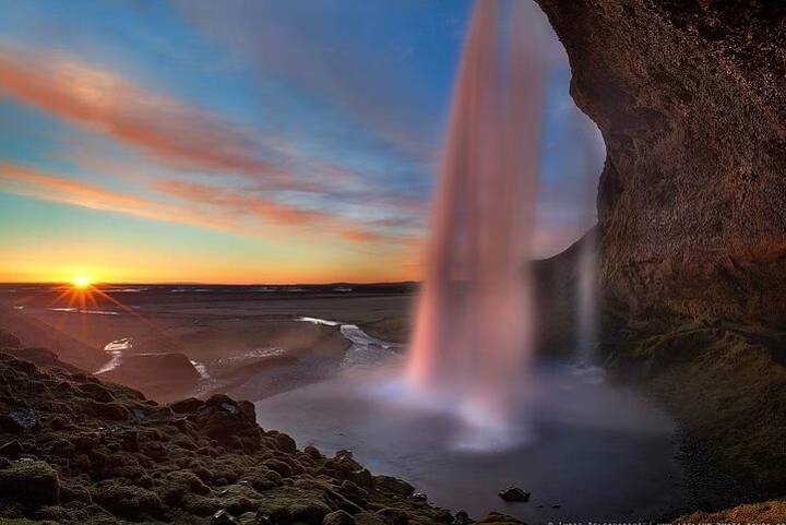 Seljalandsfoss Waterfall from behind in Iceland