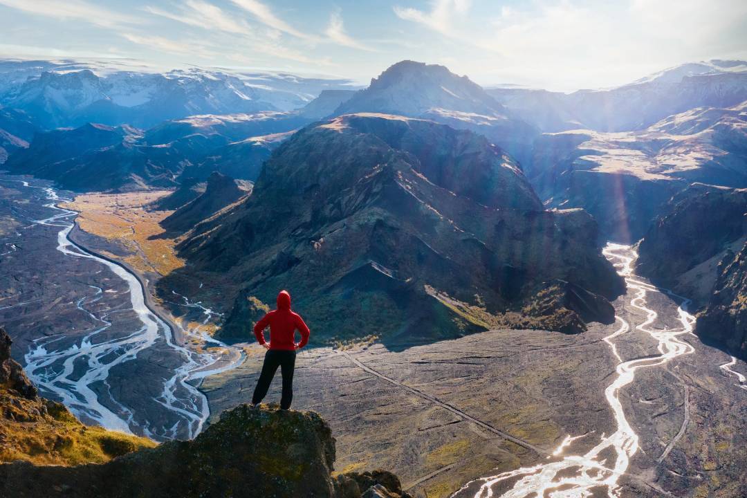 Hiker standing high above in Thorsmork (Valley of Thor)