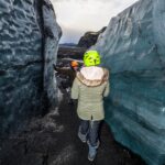 Walking through Ice Formations at Katla Ice Cave
